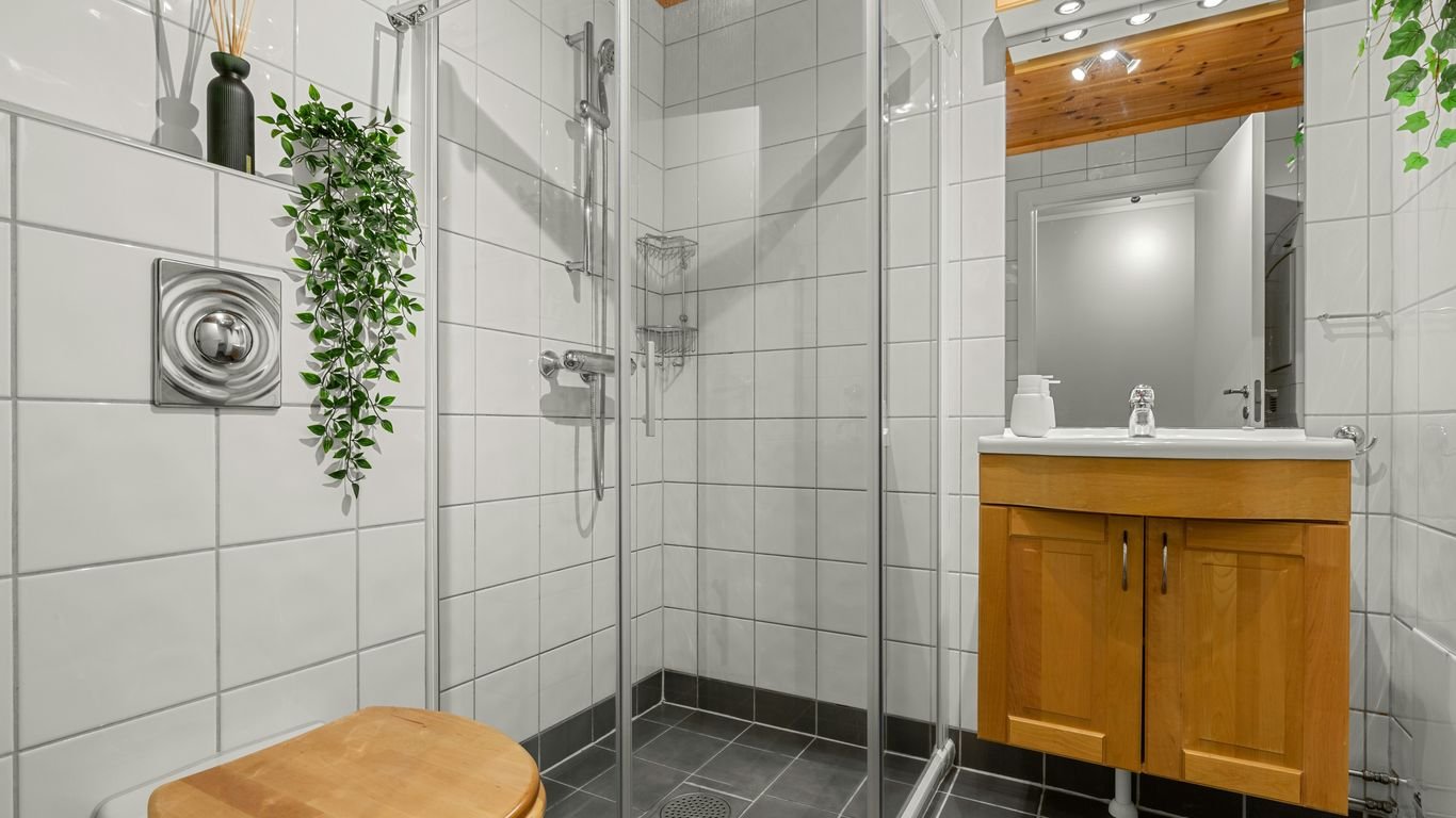 A bathroom with a toilet, sink, and shower